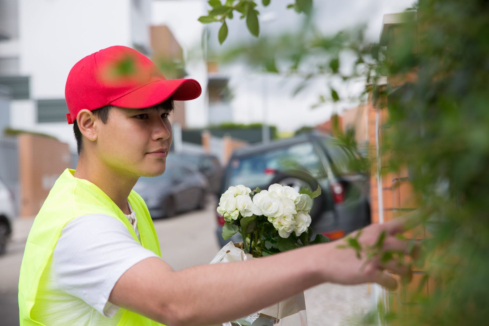 Courier delivering flowers to a residence